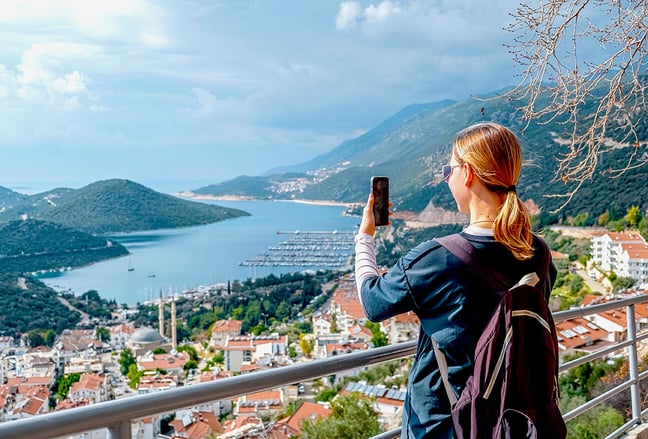 solo_traveler_above_seaside_town_@1295x879px
